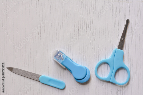 Fotografie Scissors, clipper and soother on light white table