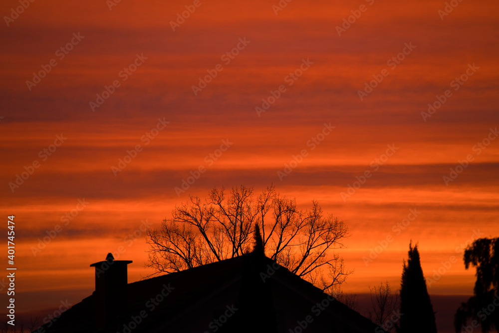 beautiful sunrise over a village with a house and trees