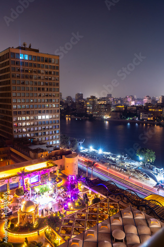 Aerial view of the city of Cairo at night along the river Nile. Skyline of the African city of Egypt
