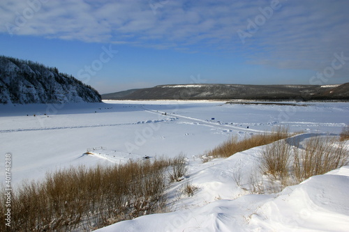 Fototapeta Naklejka Na Ścianę i Meble -  The Lower Tunguska is a river in Eastern Siberia. Winter road on a frozen river in the village of Tura.