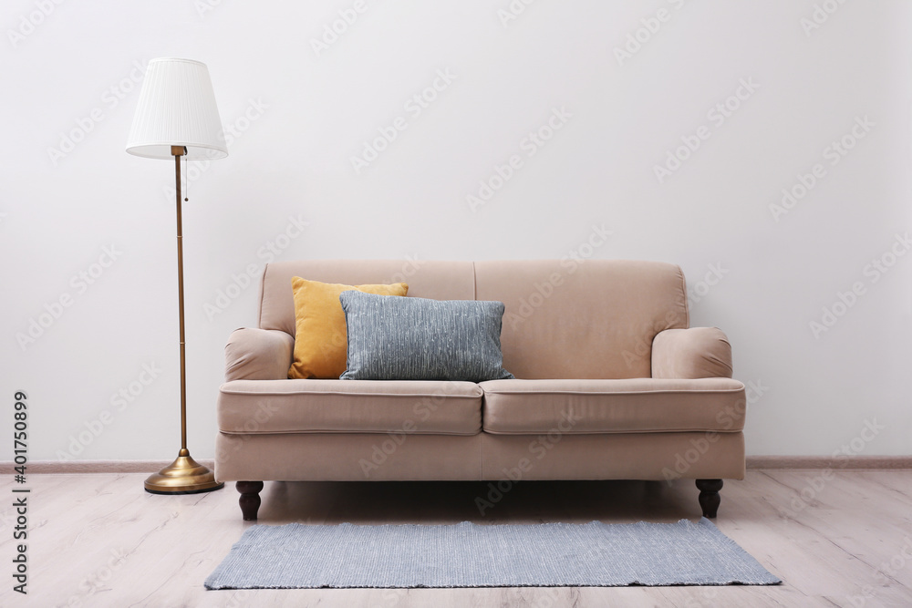 Simple room interior with comfortable beige sofa - obrazy, fototapety, plakaty 