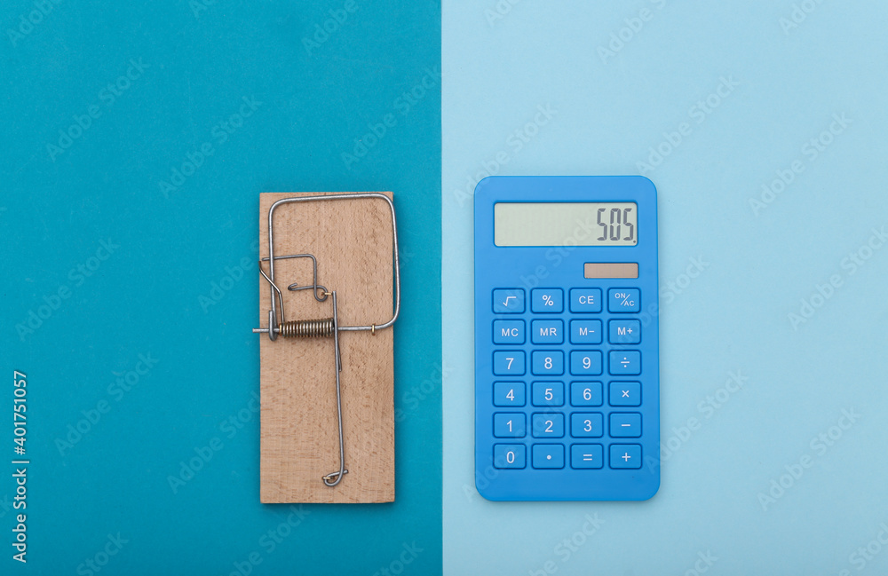 Mousetrap with calculator on blue background. Business concept