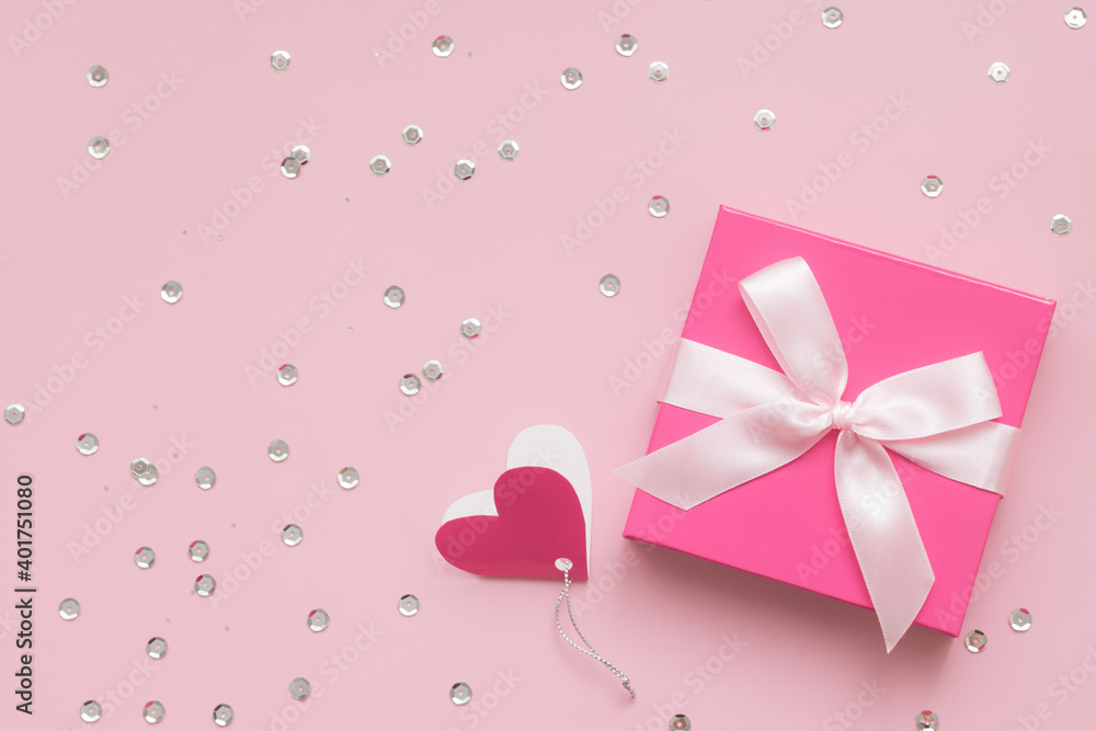 Pink gift box and confetti on pink background, Happy Valentine's Day concept Pink gift box and confetti on pink background, Happy Valentine's Day concept