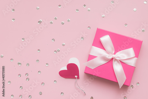 Pink gift box and confetti on pink background, Happy Valentine's Day concept