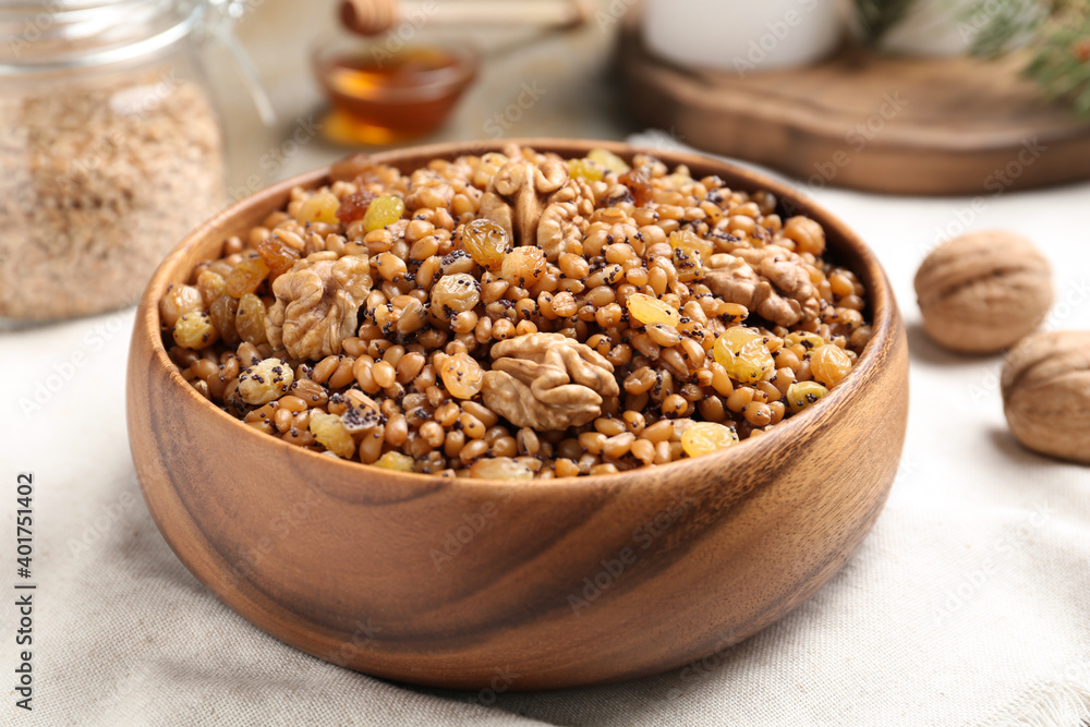 Fresh tasty traditional kutia in wooden bowl on light towel, closeup Fresh tasty traditional kutia in wooden bowl on light towel, closeup