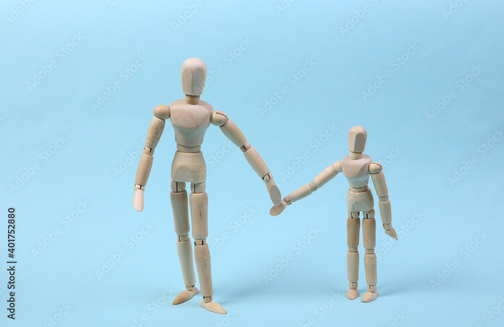 Parenthood. Two puppets hold hands on a blue background. Spending time with children Parenthood. Two puppets hold hands on a blue background. Spending time with children