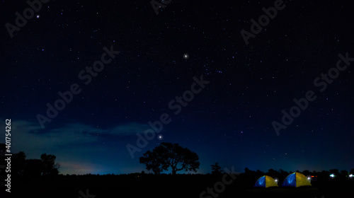 Panorama blue night sky milky way and stars. Set up a tent and stay overnight. For nature tourists