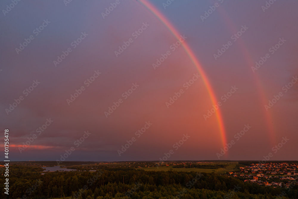 Double rainbow in the morning on horisont above the area and ields Double rainbow in the morning on horisont above the area and ields