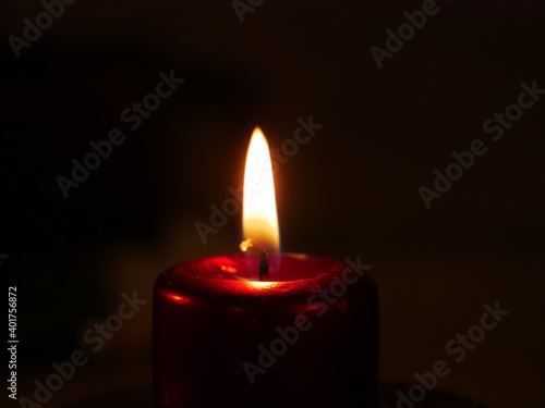 Close-up on a lit candle to make a prayer