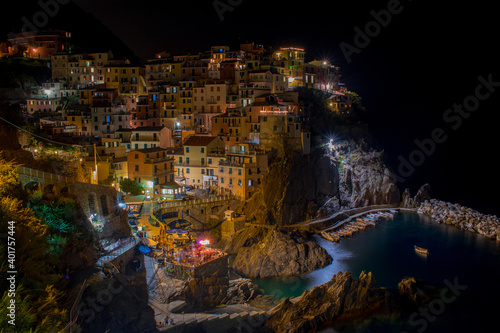 [Italy] Long exposure of Manarola coming alive at night w/- a pop up outdoor nightclub down the bottom left. © Cameron