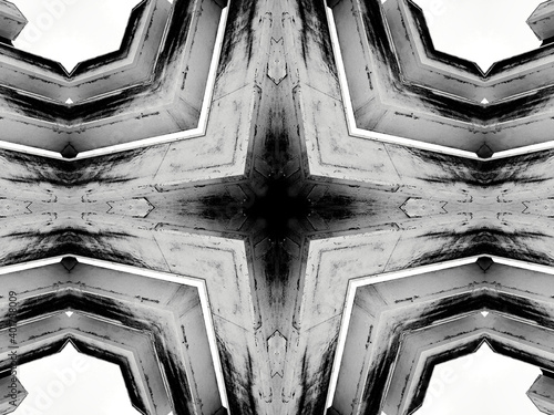 A grayscale kaleidoscope pattern of architectural details and animals on the sides
