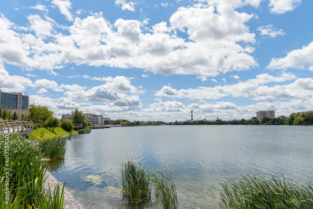 KAZAN, RUSSIA - June, 2020. Lake Nizhny (Lower) Kaban embankment, reeds, grass in the water. Kazan, Tatarstan