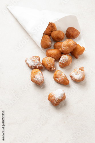 Fried beignets in a typically cornet paper, carnival food in low lands.