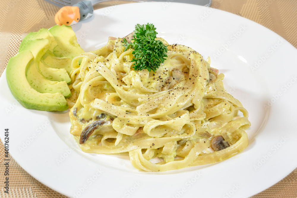 Creamy Fettuccine Alfredo with Mushroom Served along with Avocado. Creamy Fettuccine Alfredo with Mushroom Served along with Avocado.
