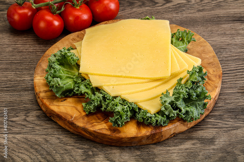 Sliced Gauda cheese over board