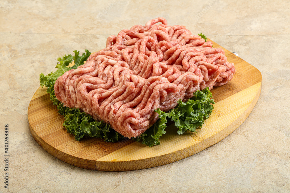 Raw pork minced meat over board Raw pork minced meat over board