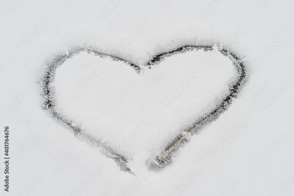 A heart is drawn in the snow. close-up. Love concept A heart is drawn in the snow. close-up. Love concept