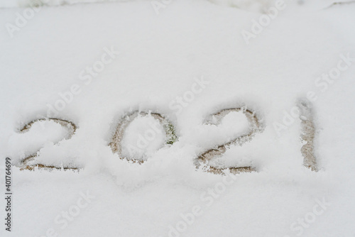 Text written in the snow, 2021. Cadaveric plan. Happy New Year greetings concept © M.V.schiuma