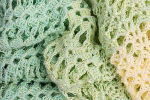 handmade multicolor crochet background in green and yellow with double crochet stitches