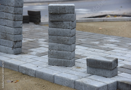 Grey road tiles stacked on top of each other on a construction site.