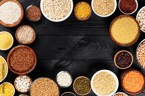 Different cereals, grains, seeds and beans, top view with copy space