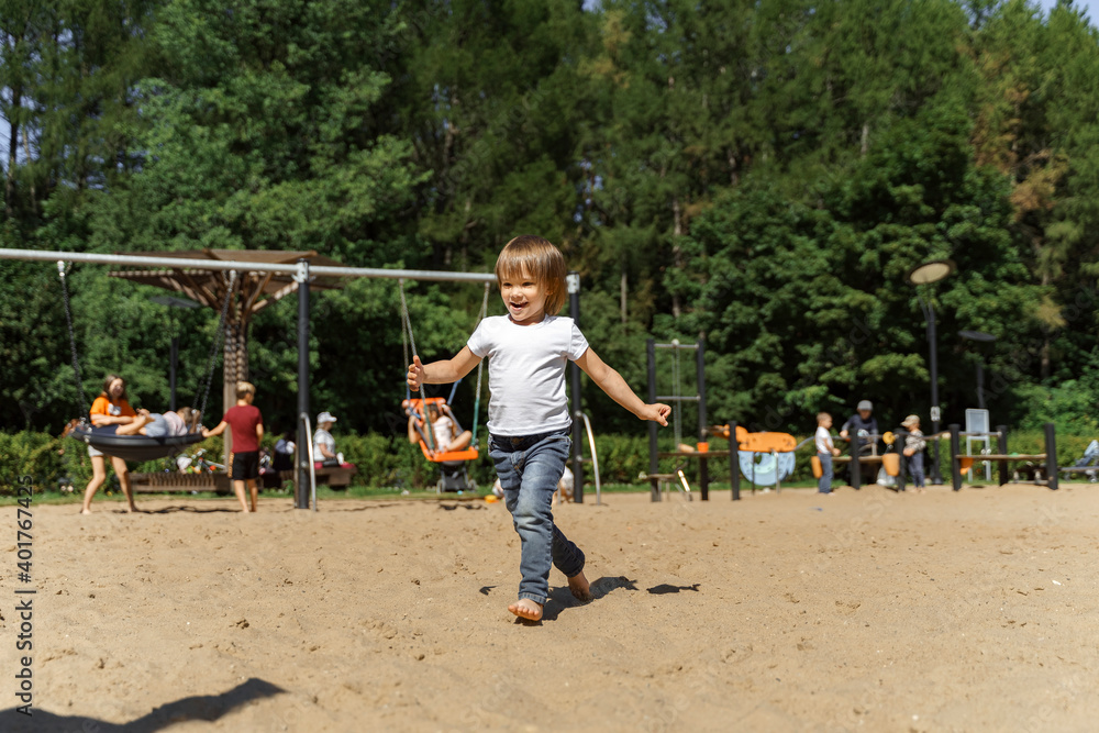 little girl in a white t-shirt with a blue ball on the beach little girl in a white t-shirt with a blue ball on the beach