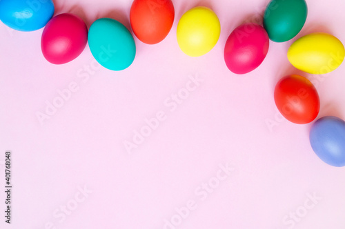 colorful easter eggs on pink background with copy space. Easter background