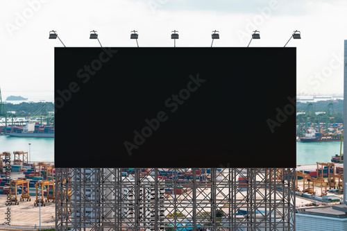 Blank black road billboard with Singapore cityscape background at day time. Street advertising poster, mock up, 3D rendering. Front view. The concept of marketing communication to promote.