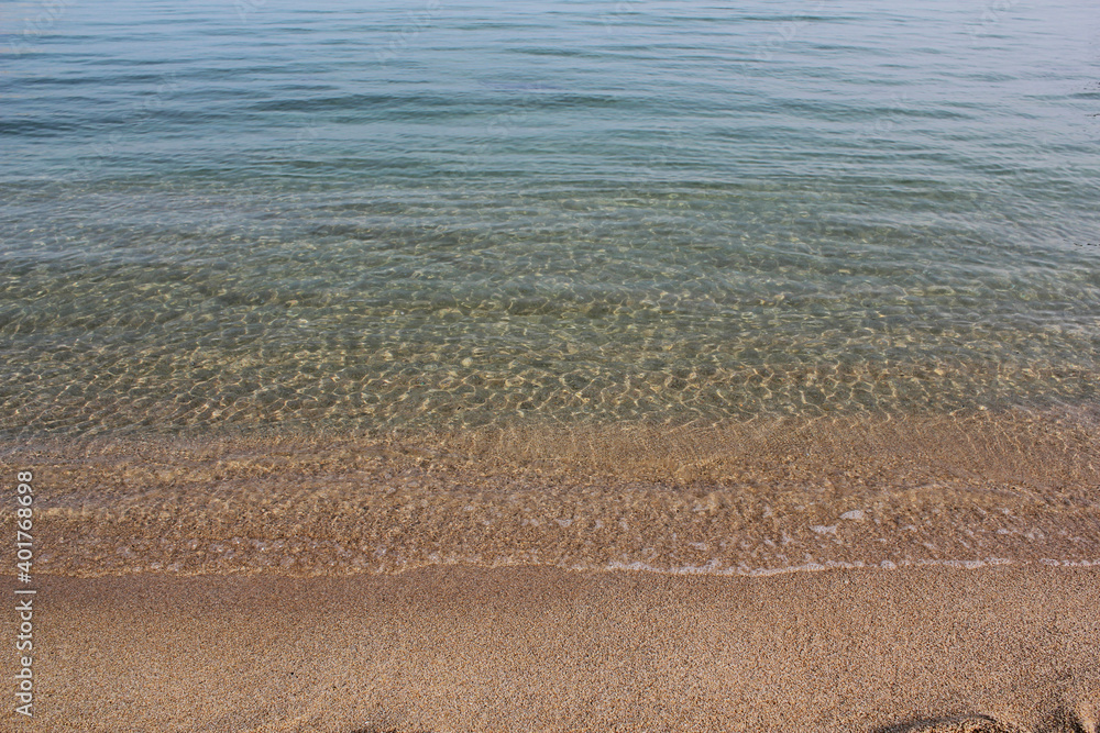 Soft beautiful ocean wave on sandy beach. Background