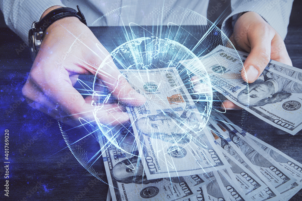 Multi exposure of financial theme drawing hologram and USA dollars bills and man hands. Business concept. Multi exposure of financial theme drawing hologram and USA dollars bills and man hands. Business concept.