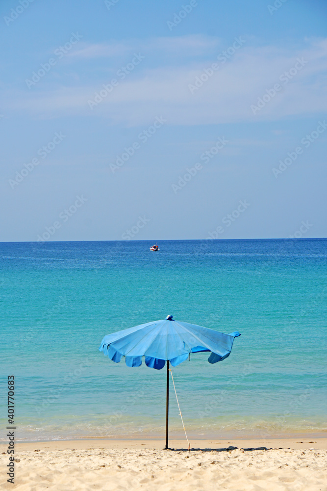 Seascape Nature scene of summer blue sky and single blue umbrella on sand beach at Karon Kata beach at  Phuket  thailand                                                                             