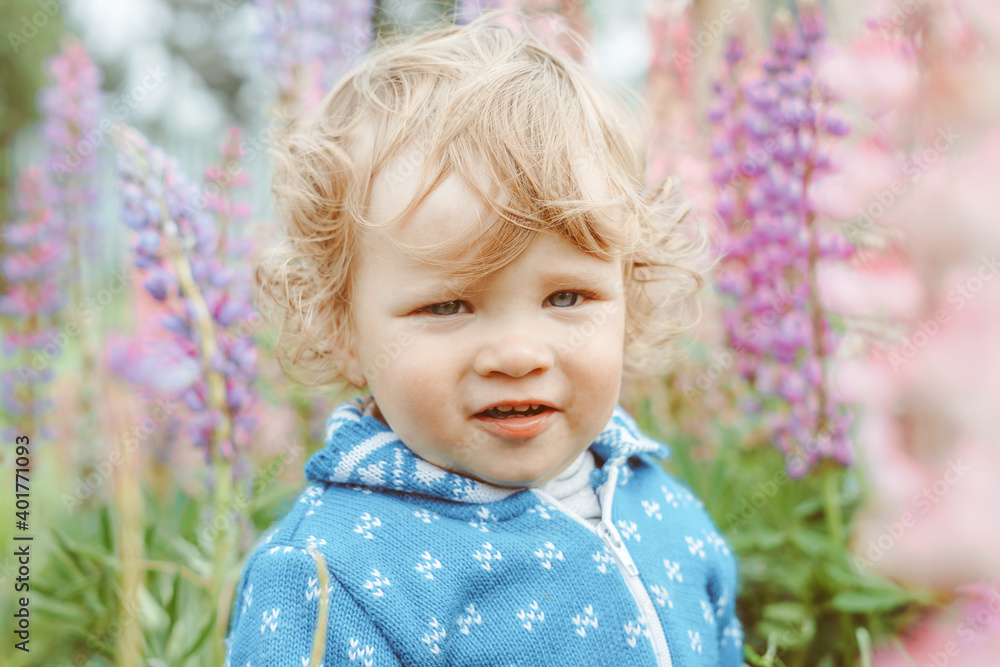 a child plays among the grass a child plays among the grass