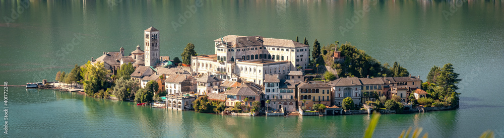The world famous Orta San Giulio island, in the Orta Lake (piedmont, Northern Italy) seen from the top of Sacro Monte di Orta. UNESCO World Heritage Site, it is home to a convent of cloistered nuns