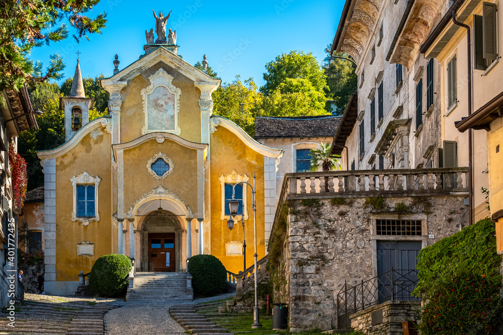 View of the street name Salita Motta, in the village of Orta (Piedmont, Northern Italy), with, at the top, the church of St. Maria Assunta.