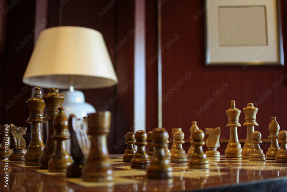 Cozy living room interior design inside bar or lounge or library on classic  luxury cruise ship or cruiseship liner with wooden wall panels and chess  game board and lamp foto de Stock