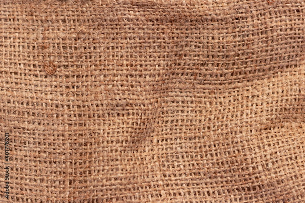 The texture of an uneven crumpled, roughly woven burlap. The texture of an uneven crumpled, roughly woven burlap.