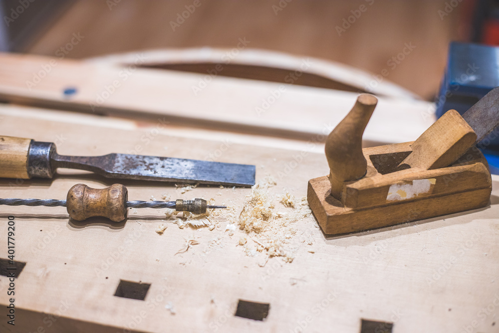 Home handyman using a plane for smoothing down a piece of timber Home handyman using a plane for smoothing down a piece of timber