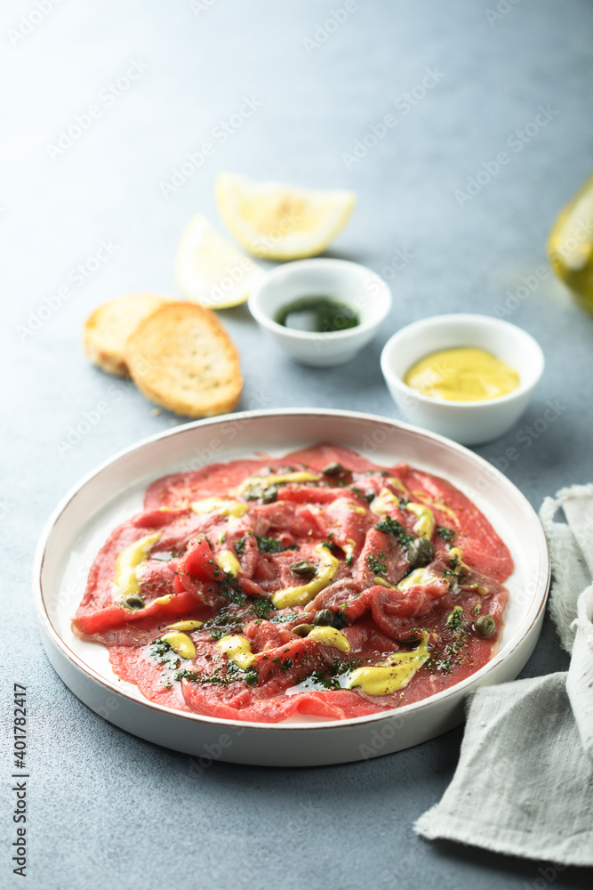 Homemade beef carpaccio with mustard sauce Homemade beef carpaccio with mustard sauce