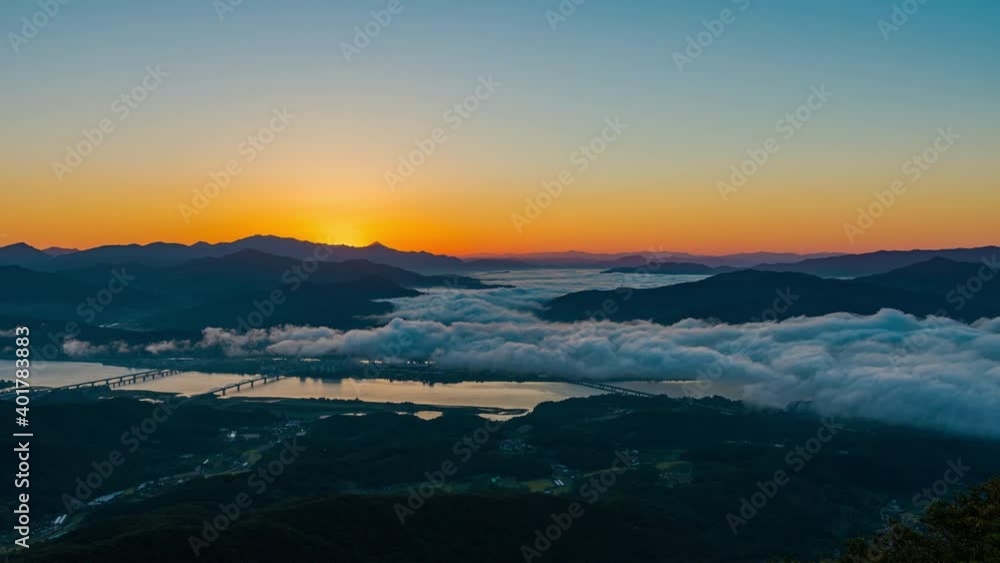 sunrise movements in morning sky.a sea of fog is formed from stratus. above the clouds at Mountains in yangsuri, South Korea sunrise movements in morning sky.a sea of fog is formed from stratus. above the clouds at Mountains in yangsuri, South Korea