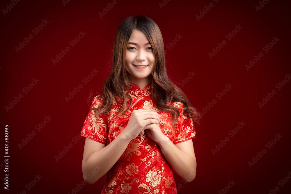 Young Chinese Asian woman with gesture of congratulation on red background, Chinese new year Young Chinese Asian woman with gesture of congratulation on red background, Chinese new year