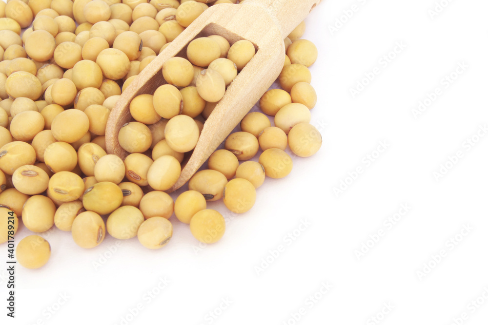 Soy beans and wooden scoop isolated on white with space for text Soy beans and wooden scoop isolated on white with space for text