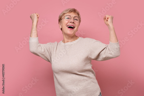 фотографія Excited aged senior female look at camera scream yes feel euphoric