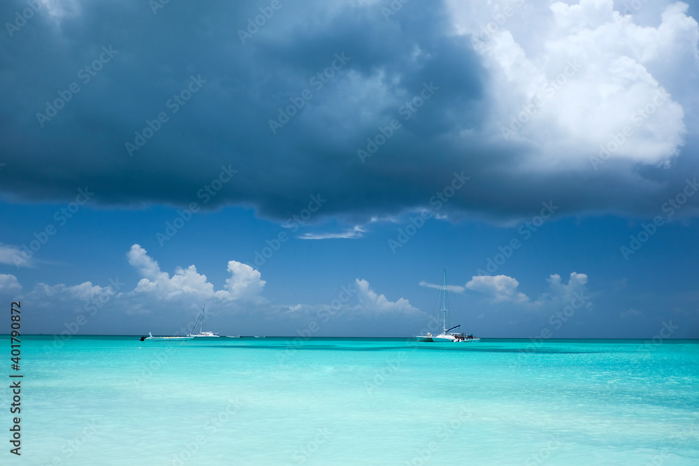 Boats in Caribbean waters, viewed from a tropical beach