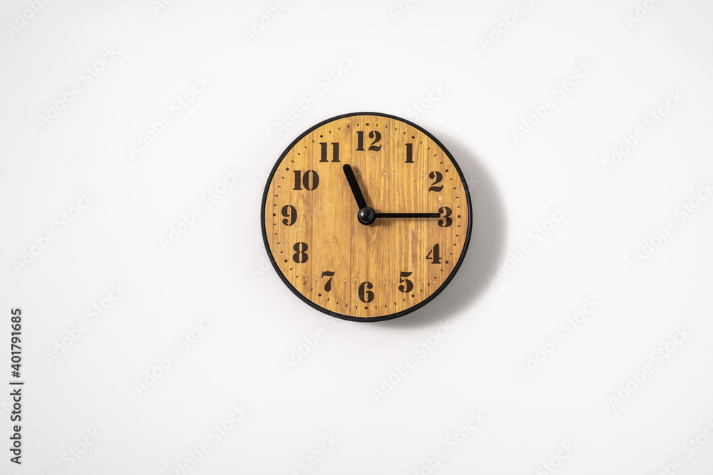 wood office wall clock with white dial on white background. wall clock on white background, top view. wood office wall clock with white dial on white background. wall clock on white background, top view.