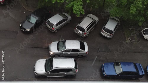 Wallpaper Mural white, silver car is driving in heavy rain, water drops are falling from the sky. view from above Torontodigital.ca