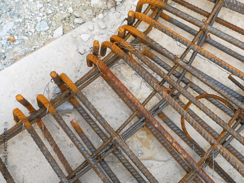 SEREMBAN, MALAYSIA -MARCH 29, 2020: Construction workers fabricating steel reinforcement bar at the construction site. They tied it together using the tiny wires before cover it up using formworks. 