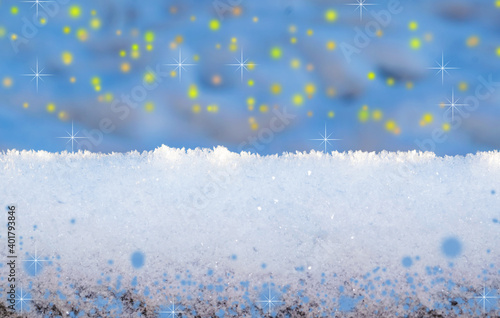 Fotografie Light wooden snow-covered boards against the background of blurred snowdrifts with bokeh
