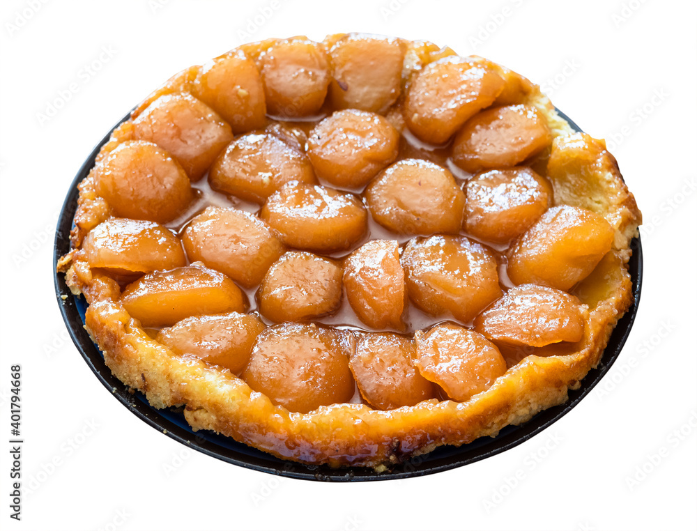 home-made caramelised apple pie Tarte Tatin on plate cut out on white background home-made caramelised apple pie Tarte Tatin on plate cut out on white background