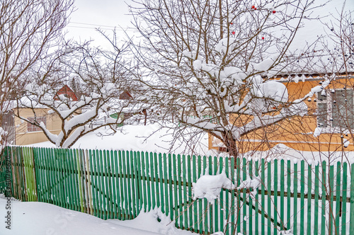 Real Russian winter, when frost and a lot of snow, in the country village, with small houses, roads through high snowdrifts