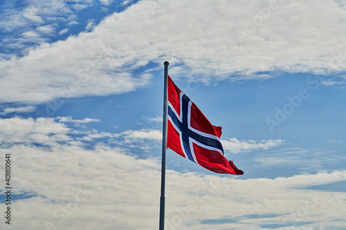 national flag of norway in a cloudy sky © T_Star